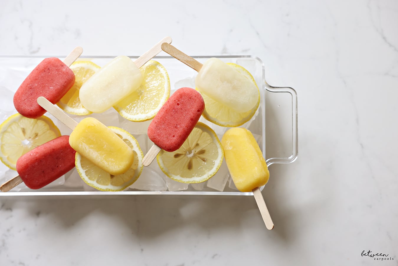ice pops on a lucite platter, layered with some ice first
