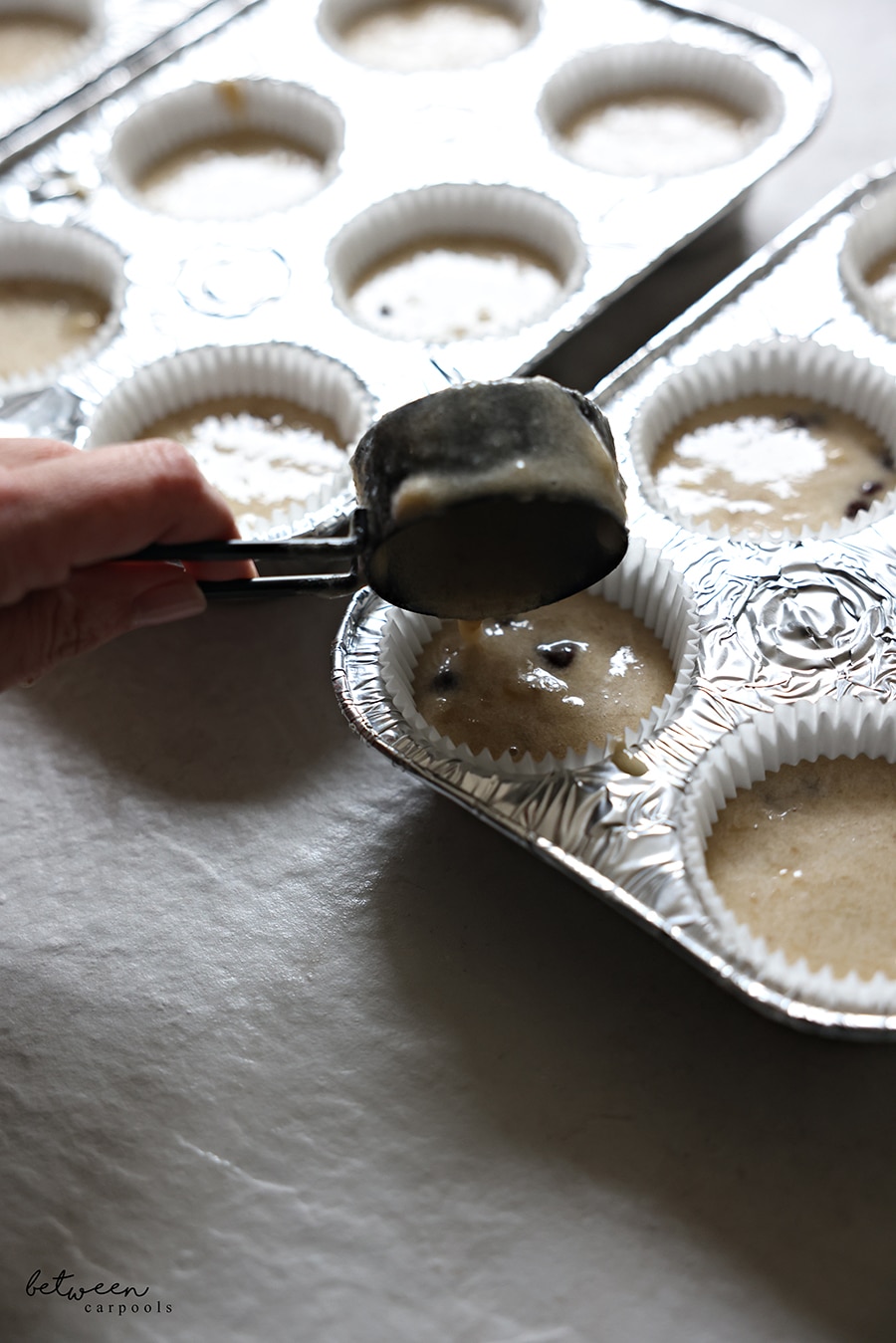 Filling the muffin liners about ¾ of the way up with batter