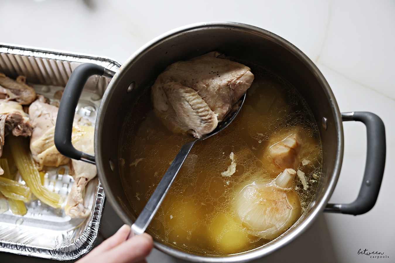 removing cooked chicken from the soup