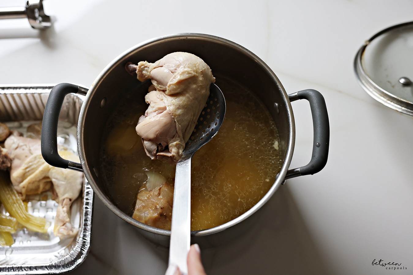 removing cooked chicken from the soup