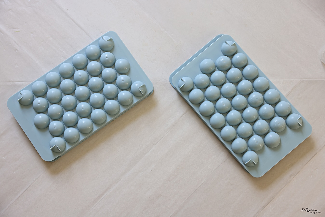 2 Ice Trays of frozen Ice Balls turned over - holes on the bottom