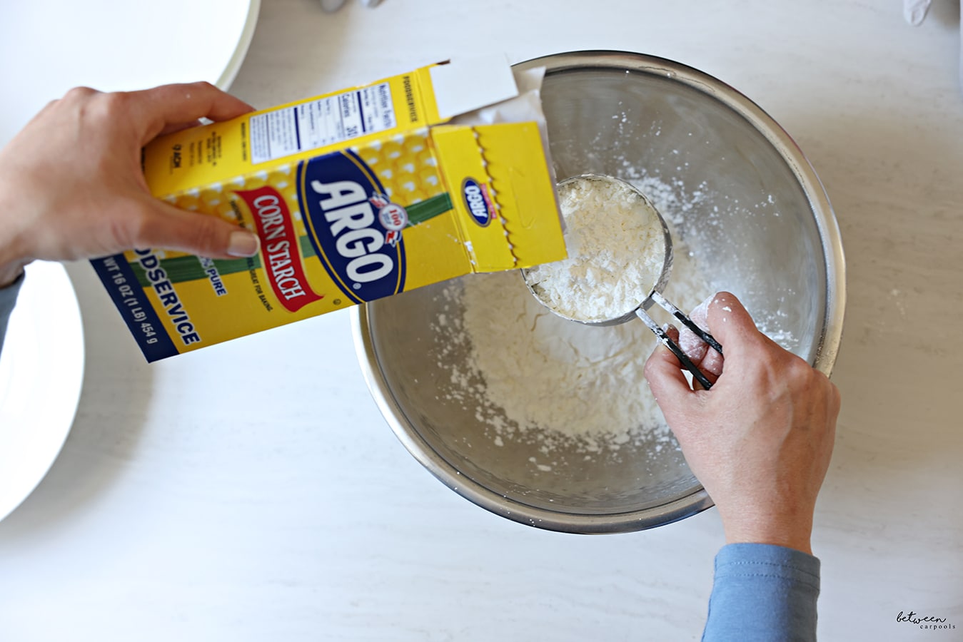 Adding corn starch to a metal mixing bowl