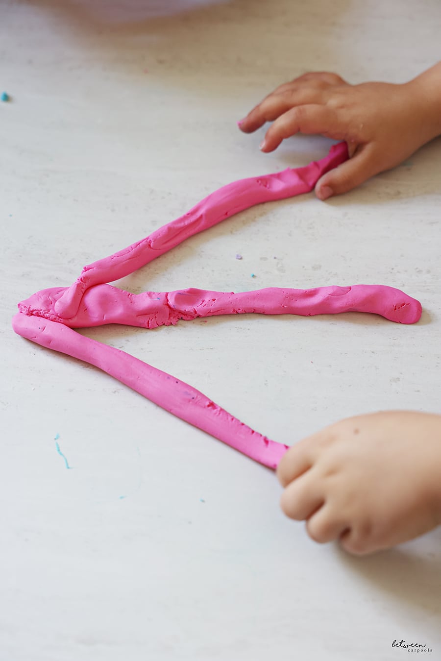 3 strands of pink homemade Play-Doh/slime