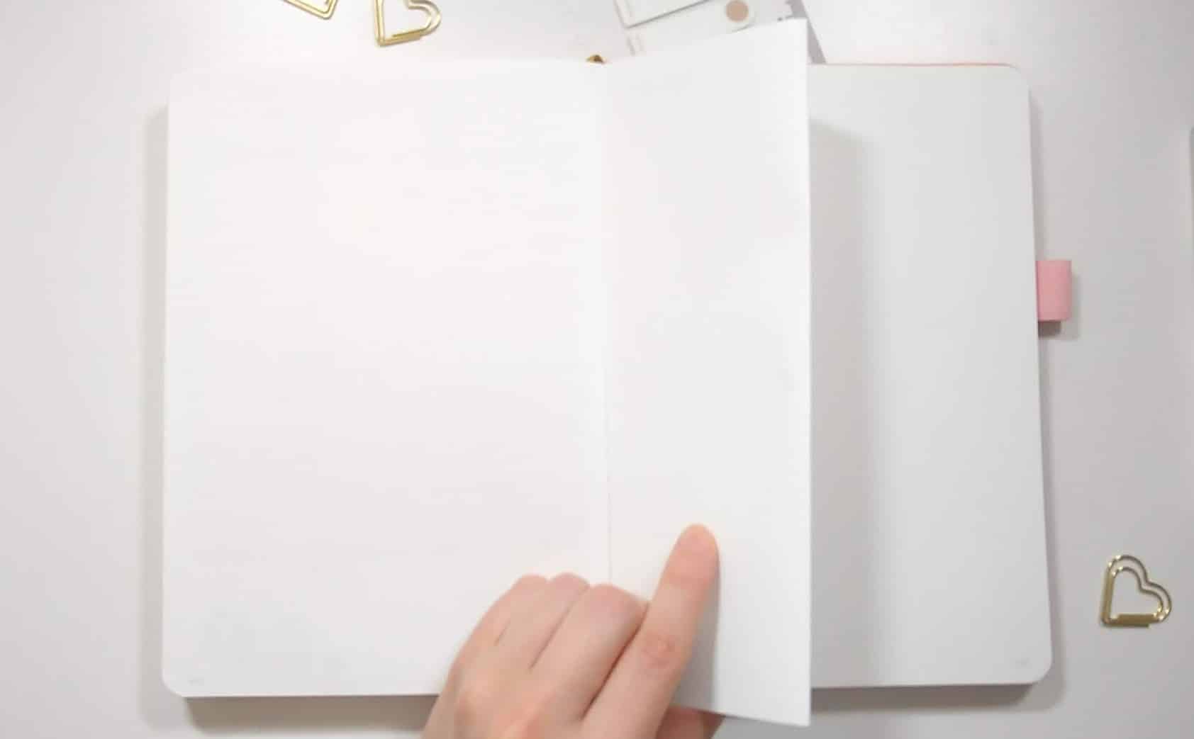 open journal, holding onto a blank page