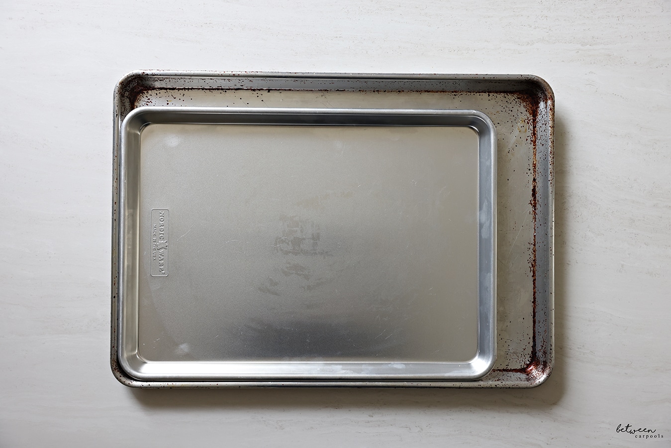 rimmed metal sheet pans, half sheet and big sheet size - stacked