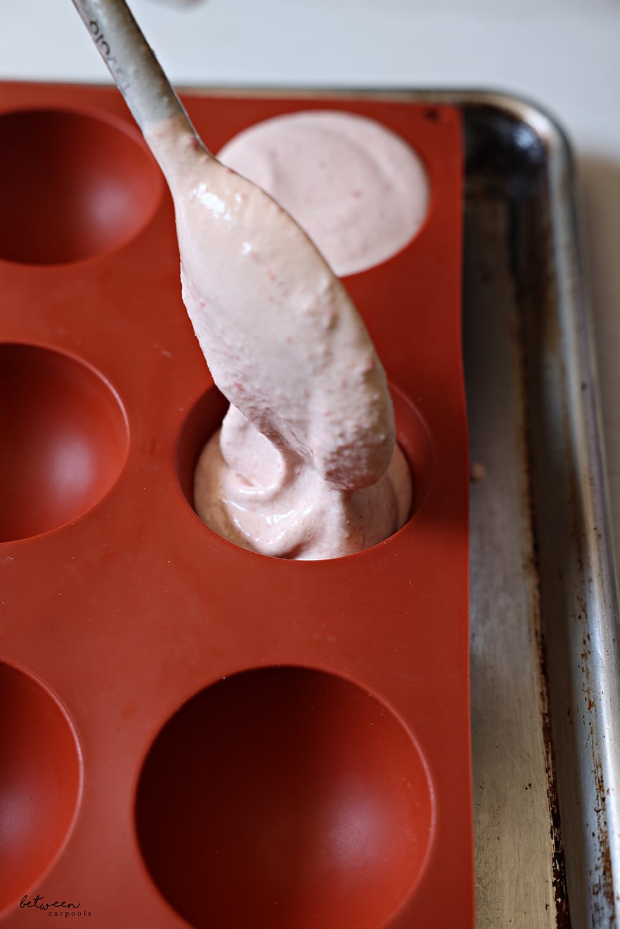 spooning ice cream in to silicone molds