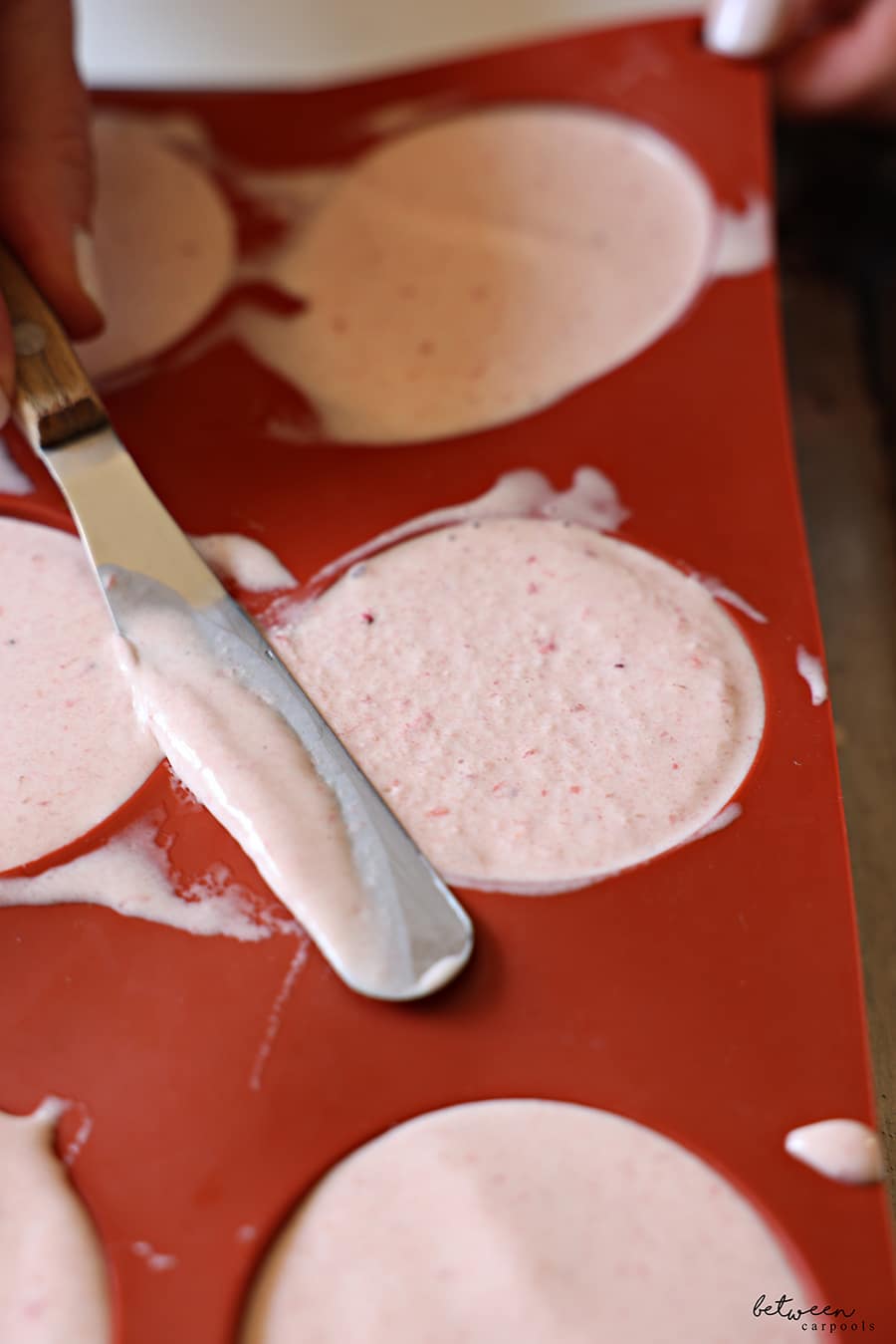 leveling ice cream spooned in to silicone molds