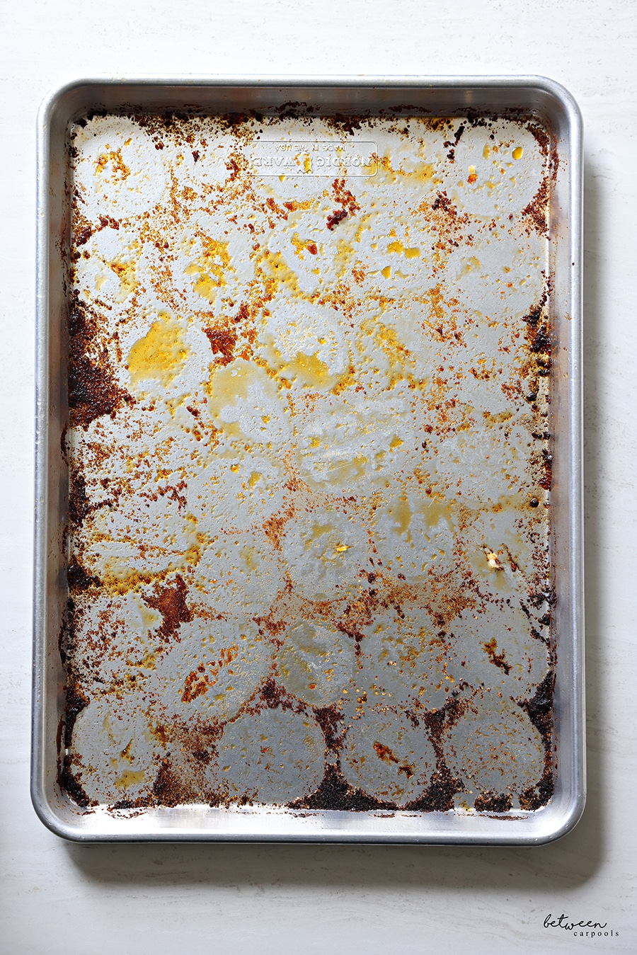 Metal sheet pan dirty from roasted potatoes