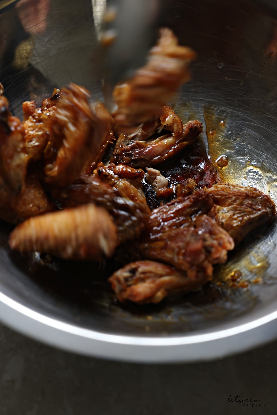 Tossing wings with the glaze.