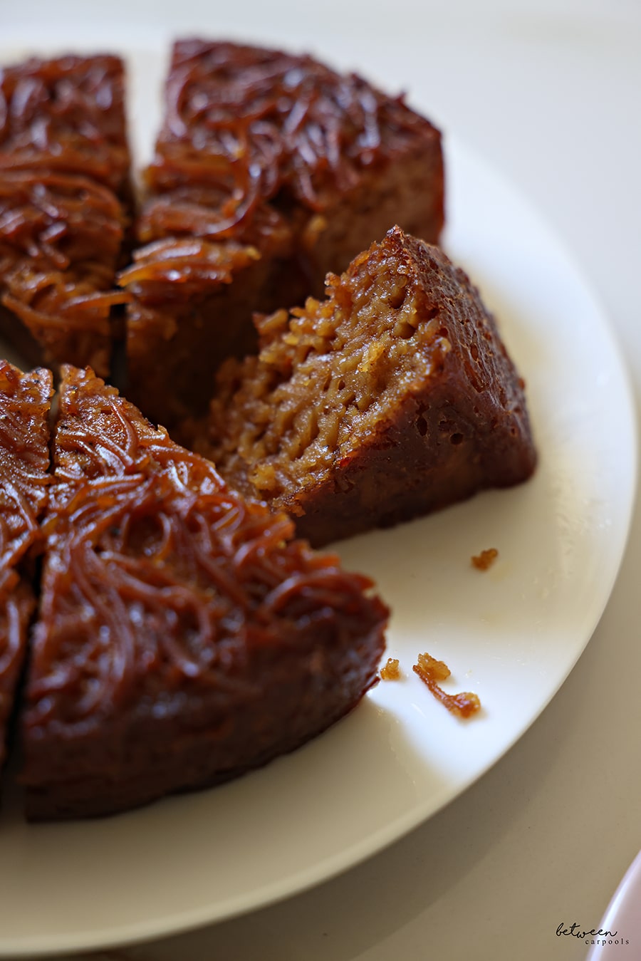 Closeup of Yerushalmi Kugel, sliced, on a plate.