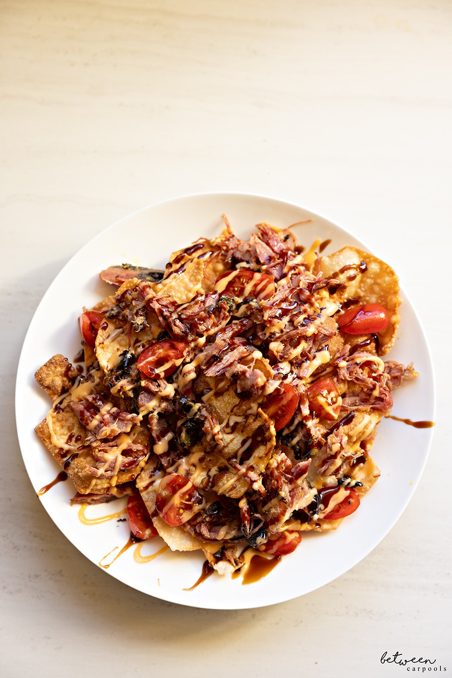 Pastrami dreidel nachos on a white dinner plate.