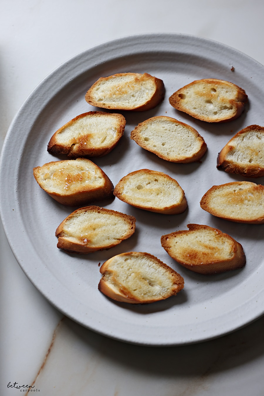 Brruschetta - toasted baguette slices - on a plate.
