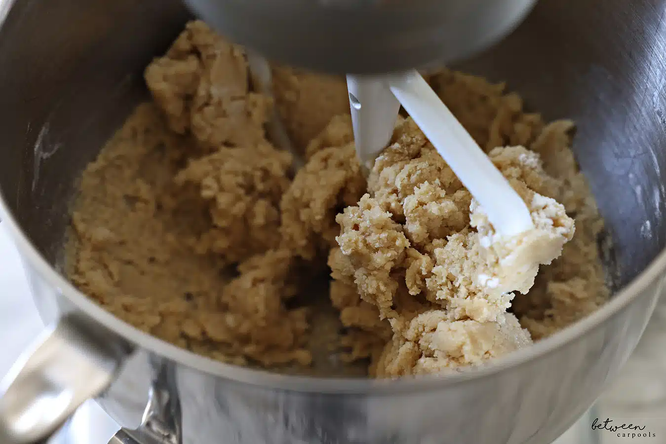 Mixing cookie dough in the metal bowl of a Kitchen Aid mixer with the flat beater.