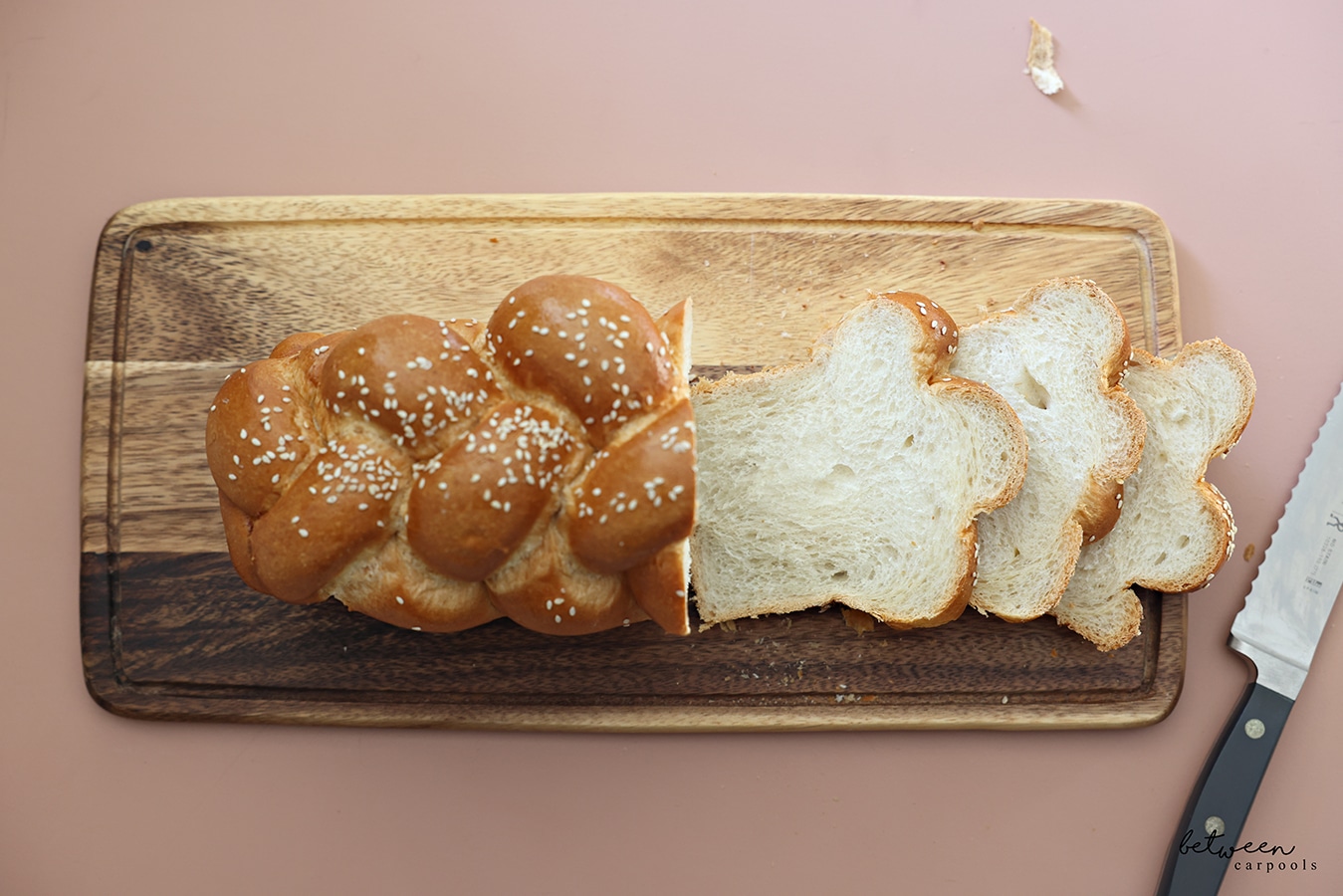 Slices of challah on a wooden board.