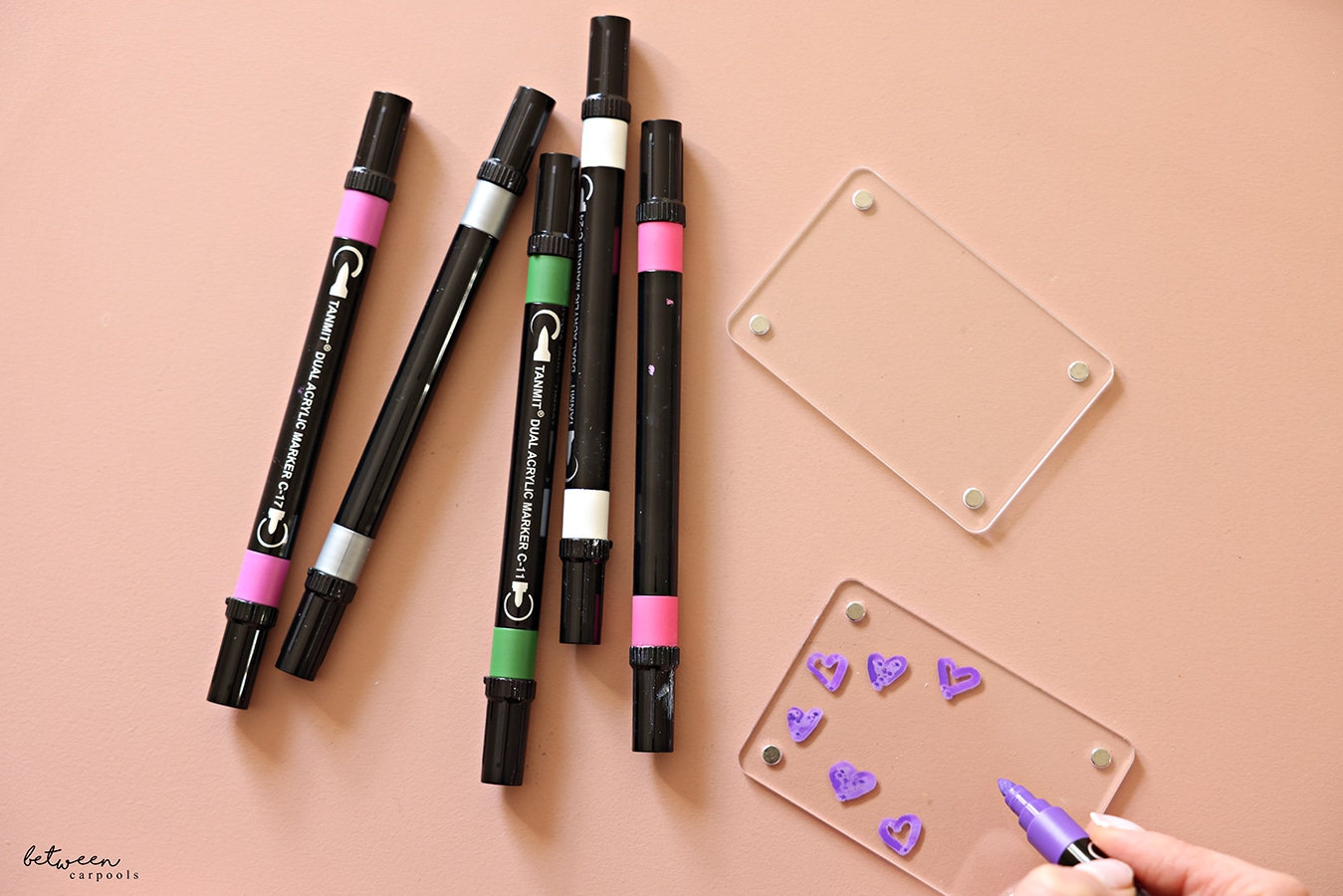 Decorating - drawing hearts - on one half of a magnetic acrylic frame with acrylic paint markers.
