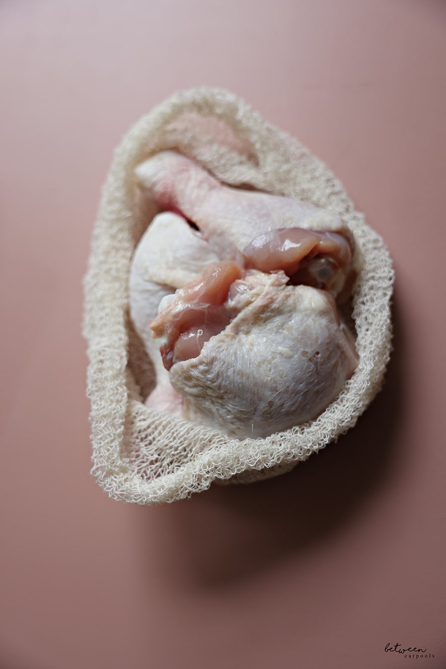 Some chicken drumsticks and thigh in a soup bag.