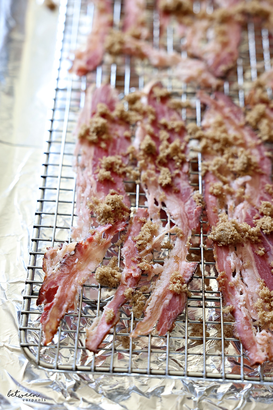 Facon and dark brown sugar on a cooling rack on a foil lined baking sheet.