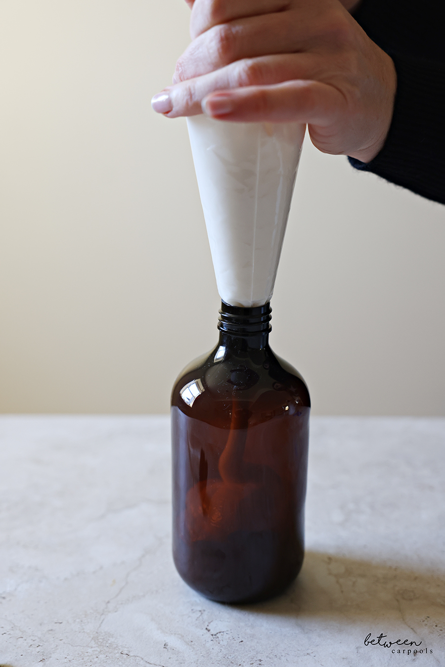 Piping Dove body wash into an Amber Pump Bottle.