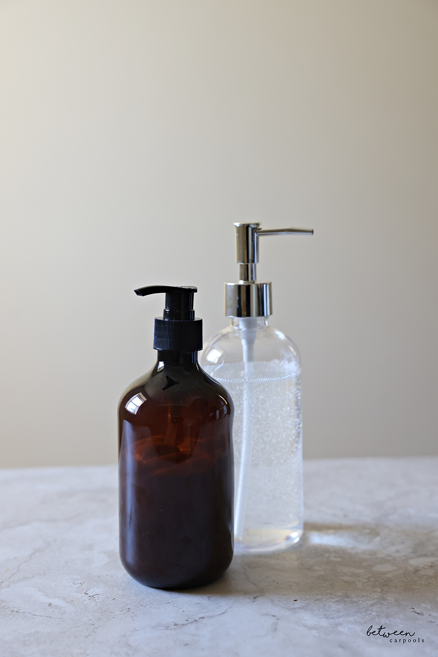 One Clear Soap Dispenser with Pouring Palmolive Ultra Pure + Clear Liquid Dish Soap Detergent - Fragrance Free, and an Amber Pump Bottle with Dove body wash.