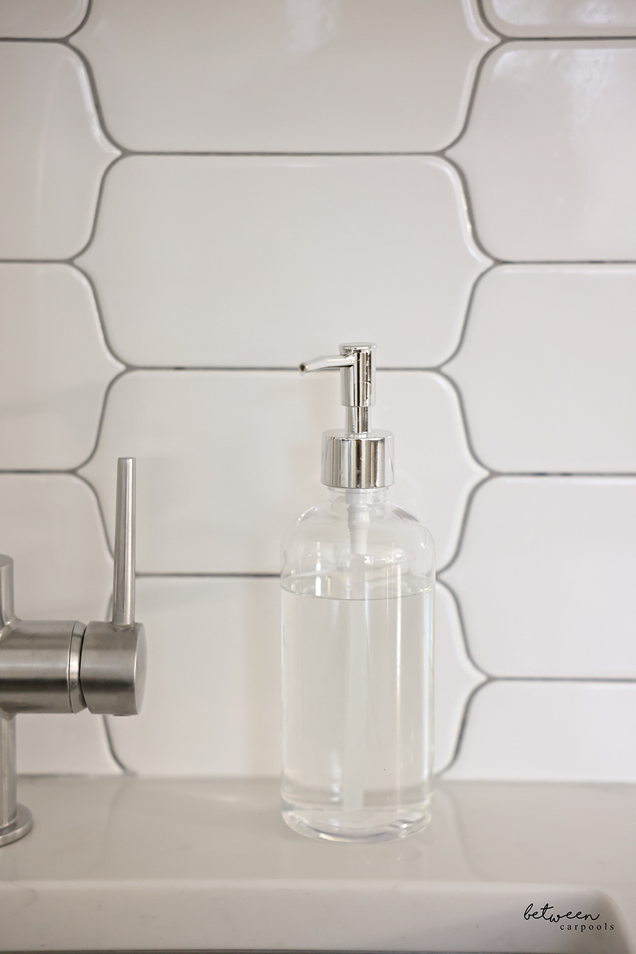 Palmolive Ultra Pure + Clear Liquid Dish Soap Detergent - Fragrance Free in a Clear Soap Dispenser near a kitchen sink.