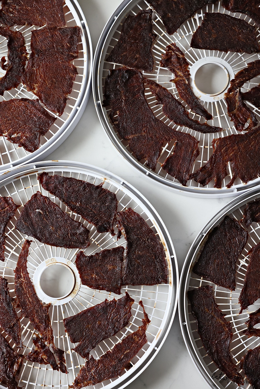 Beef Jerky on dehydrator trays.