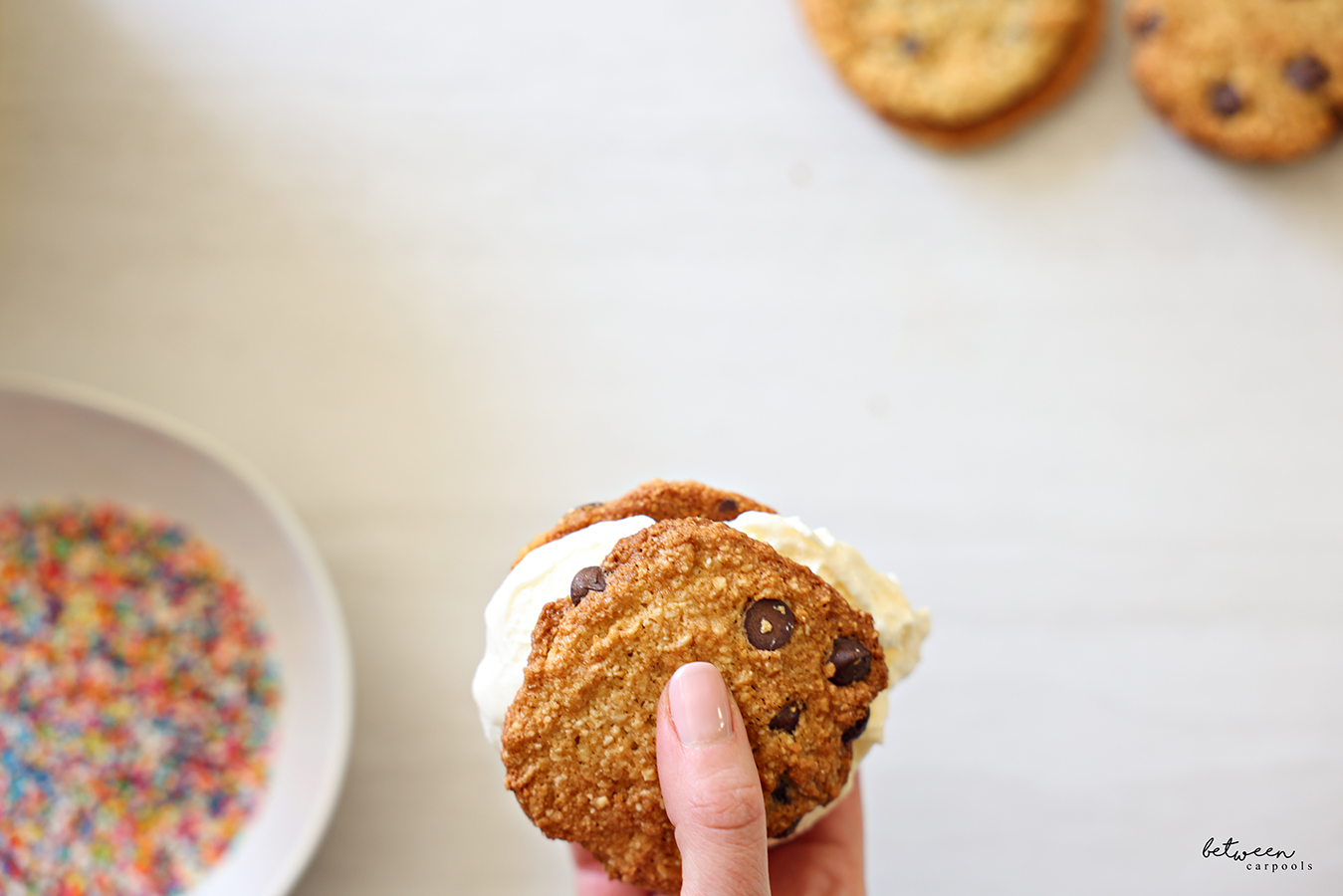 Holding an ice cream sandwich in right hand.