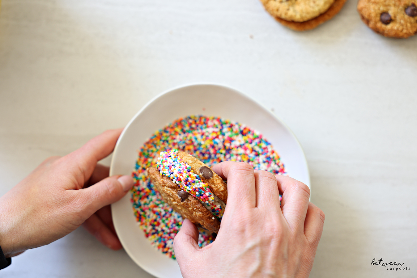 Dipping an ice cream sandwich in Non-pareils.