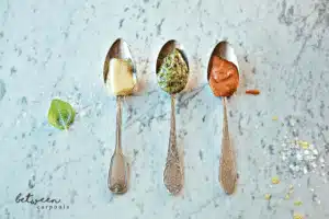 3 silver spoons, each with a pasta sauce: Penne a la Vodka, Pesto Cream Pasta Sauce and Alfredo Sauce