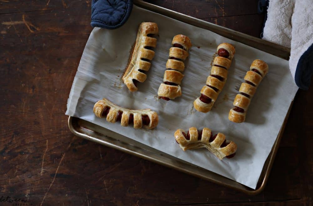 pull apart hot dogs, baked, on a parchment lined baking sheet