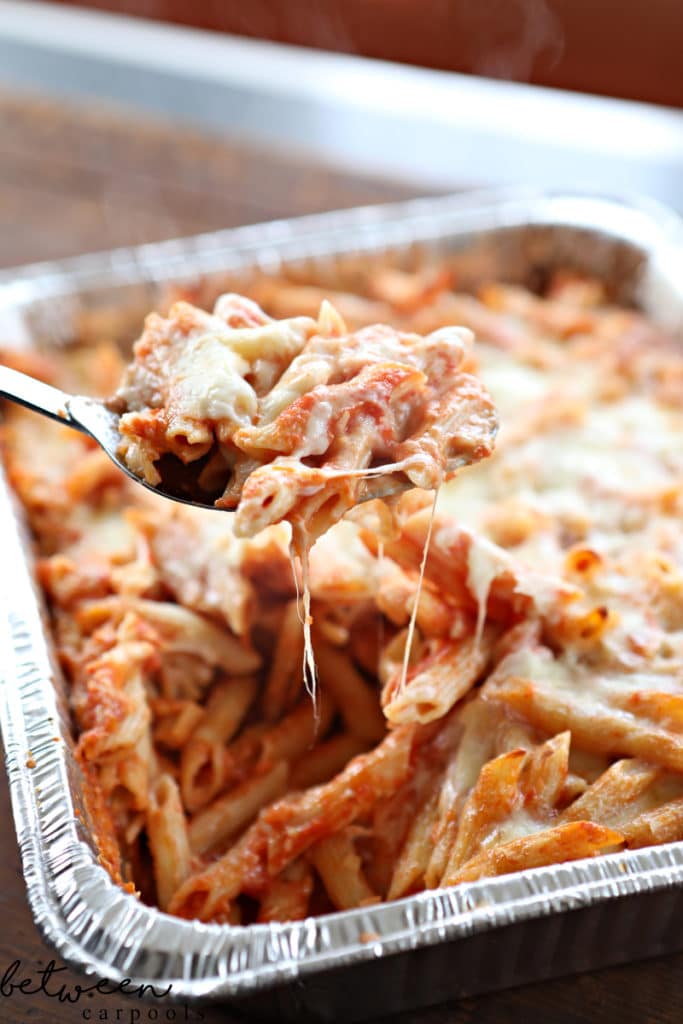 a spoonful of baked ziti from the pan, closeup