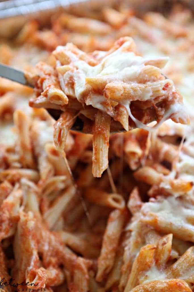 a spoonful of baked ziti from the pan, closeup