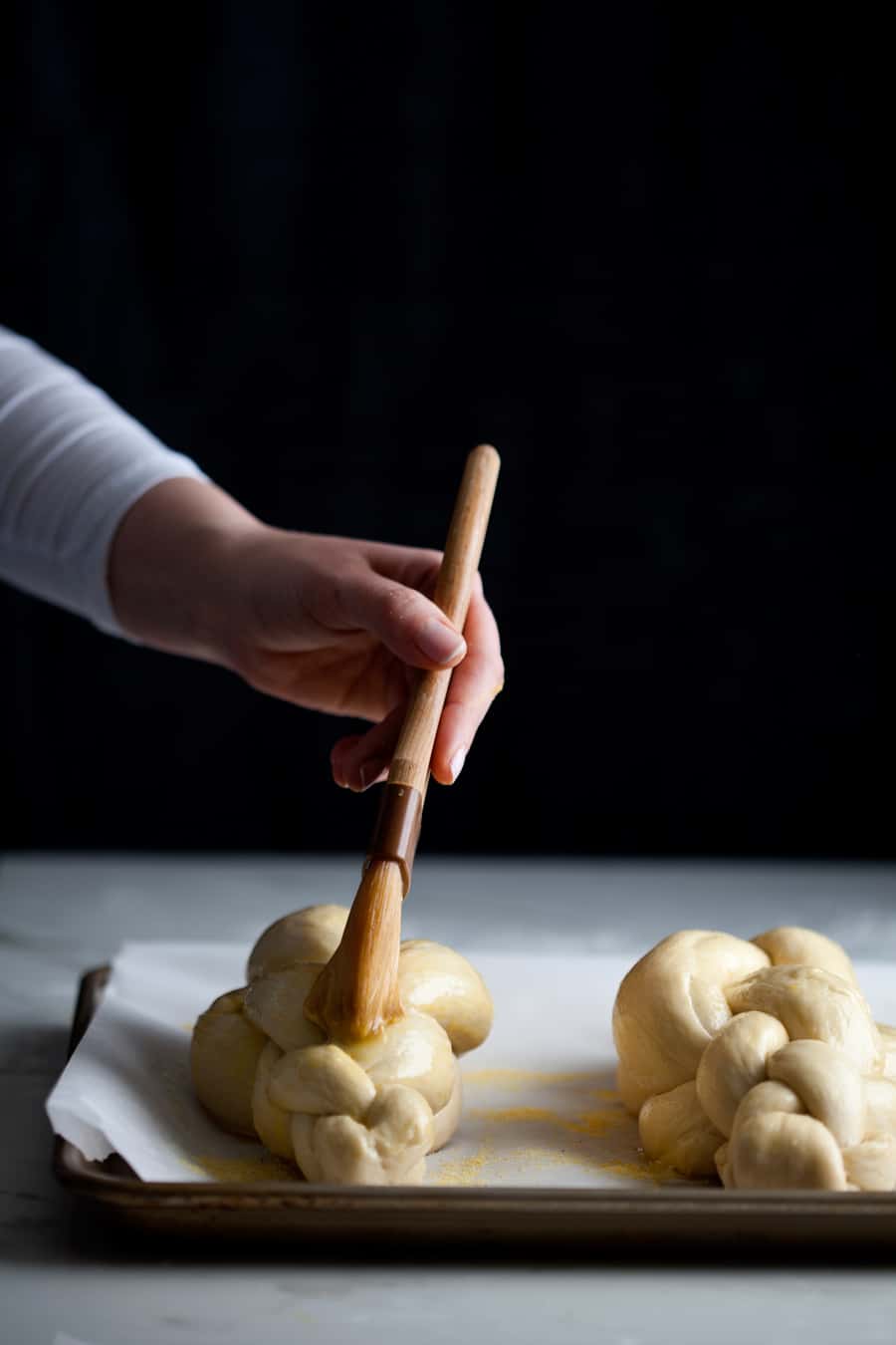 Watch and learn how to braid a 4 strand challah, bakery style. Tips on how to braid beautiful challha loaves, every time: To achieve beautiful, even loaves, it is important to focus on the strands. First, you want to make sure they are even in size. My aunt, who taught me this particular braiding method, recommended weighing each piece of dough to achieve uniformity. As soon I started I was hooked. It makes all the difference. I find 4.5-5 ounces per strand works for me. Second, roll those strands to perfection. You want to see a gradual increase toward the middle, not a big belly.