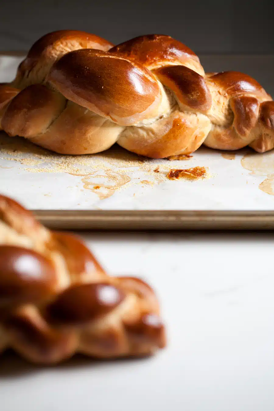 Watch and learn how to braid a 4 strand challah, bakery style. Tips on how to braid beautiful challha loaves, every time: To achieve beautiful, even loaves, it is important to focus on the strands. First, you want to make sure they are even in size. My aunt, who taught me this particular braiding method, recommended weighing each piece of dough to achieve uniformity. As soon I started I was hooked. It makes all the difference. I find 4.5-5 ounces per strand works for me. Second, roll those strands to perfection. You want to see a gradual increase toward the middle, not a big belly.