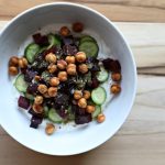 Assembled Savory Greek Yogurt Bowl on a wooden cutting board, top view.