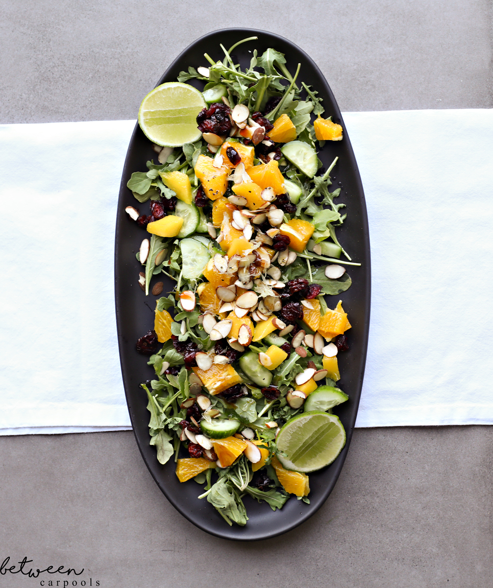Mango Salad with Silan and Lime Dressing on a black oval platter.