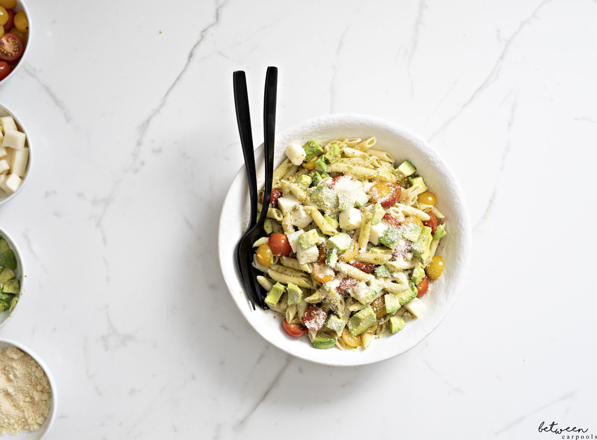 Pesto Mozzarella Pasta in a bowl with serving pieces