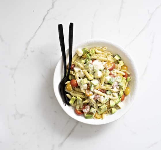Pesto Mozzarella Pasta in a bowl with serving pieces