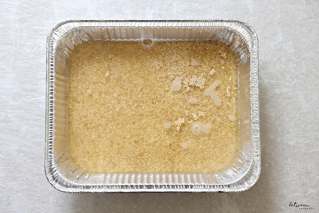 1 cup quinoa, 2 cups of boiling water, ½ tsp of salt, and ½ tsp of oil in a 9 x 13 aluminum foil pan.