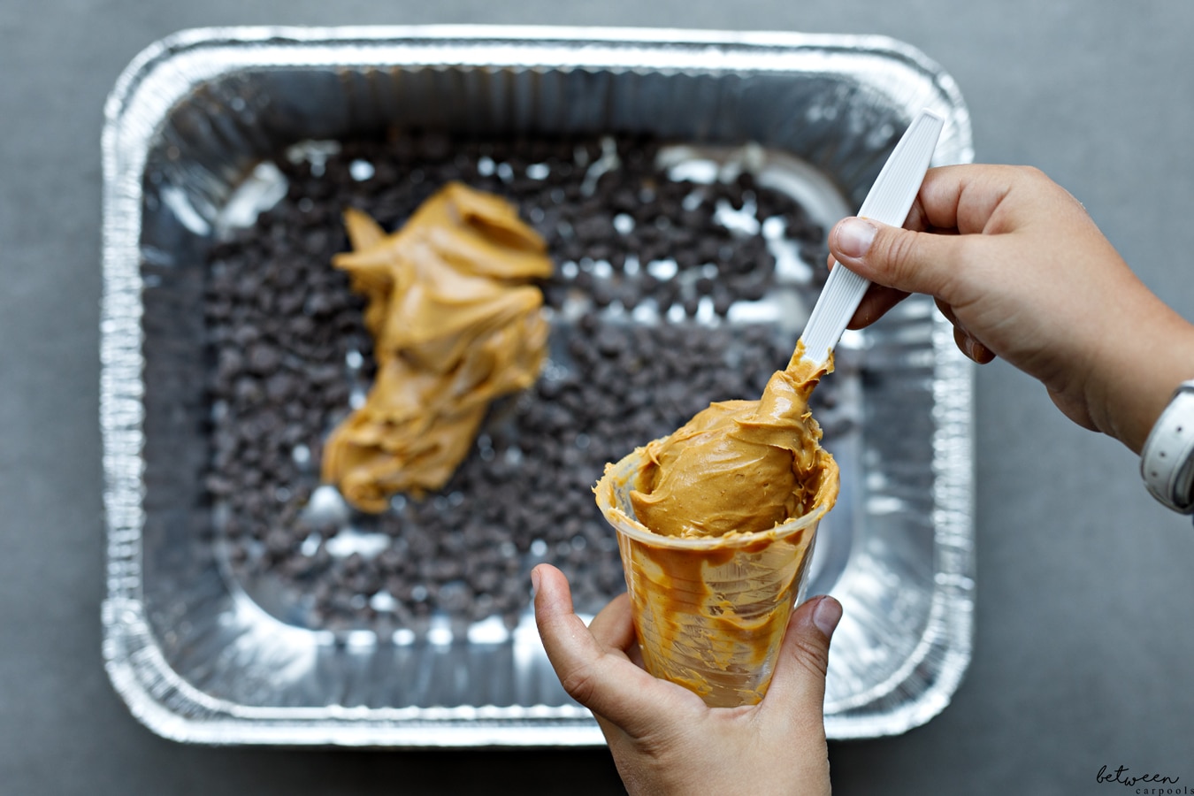 Chocolate chips and peanut butter in a 9x13 pan.