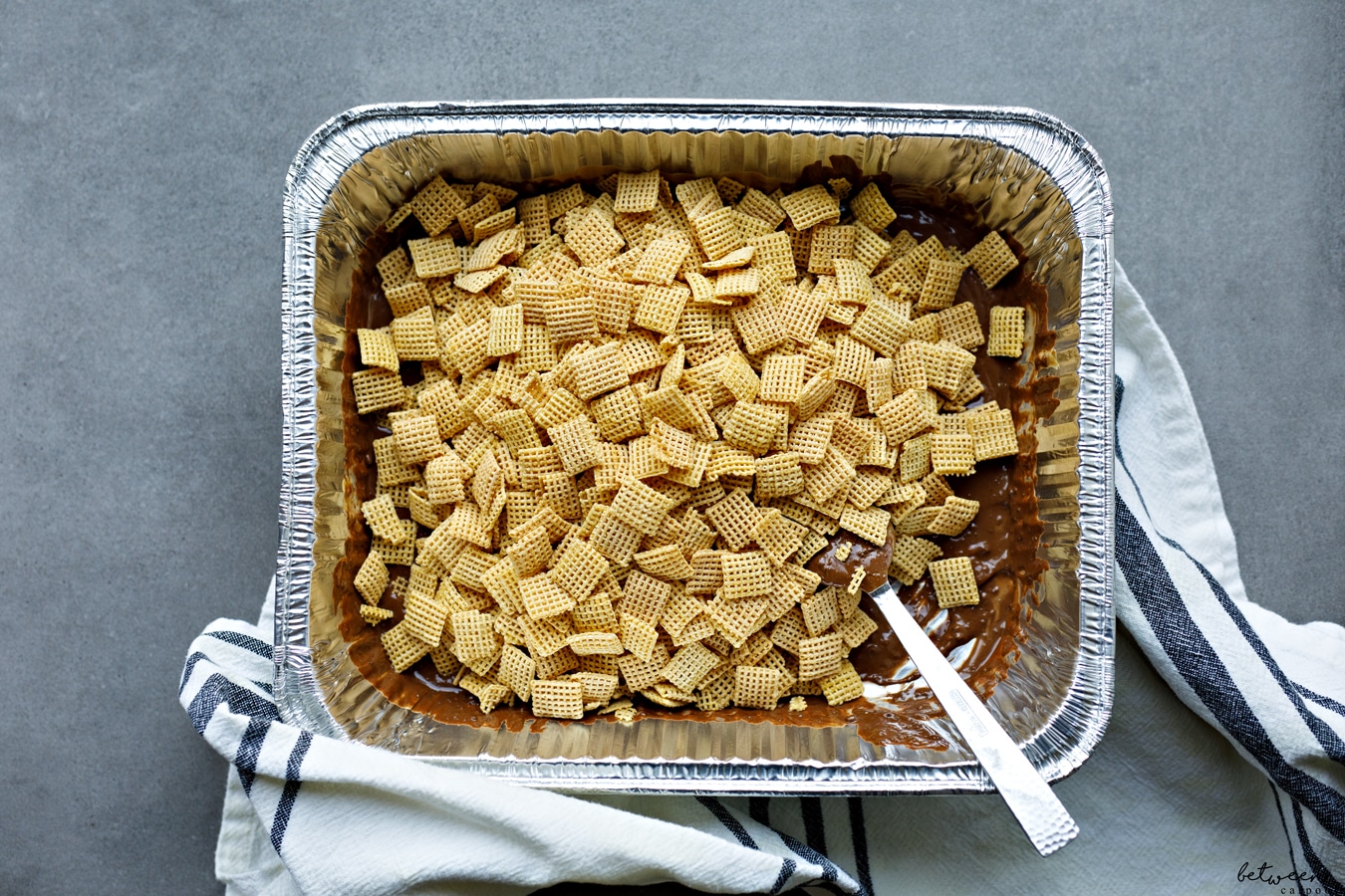 Chex in a 9x13 pan with melted chocolate chips, peanut butter and vanilla extract.