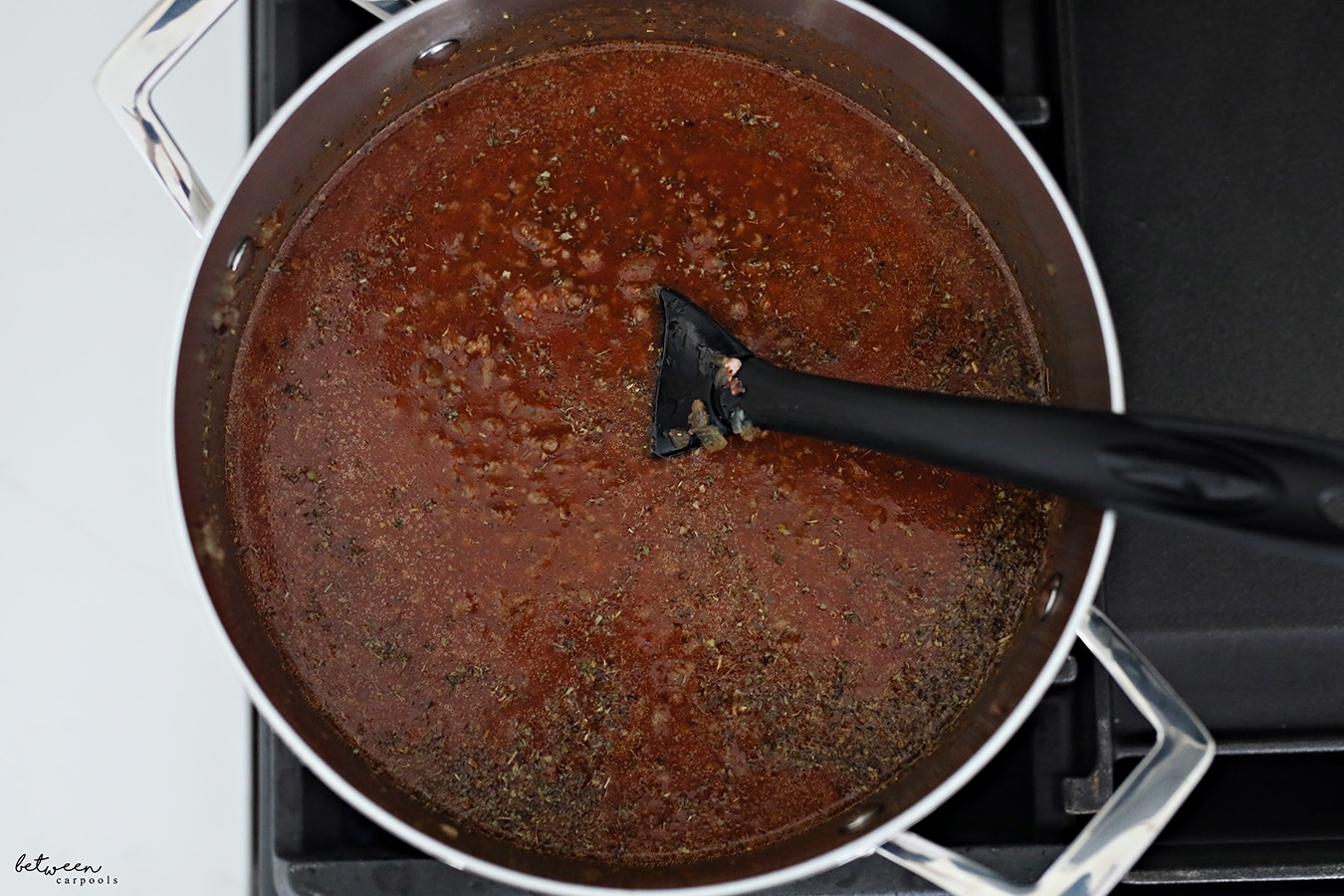 Bring marinara sauce, Italian seasoning and water to a boil for spaghetti and meat sauce in one pot.