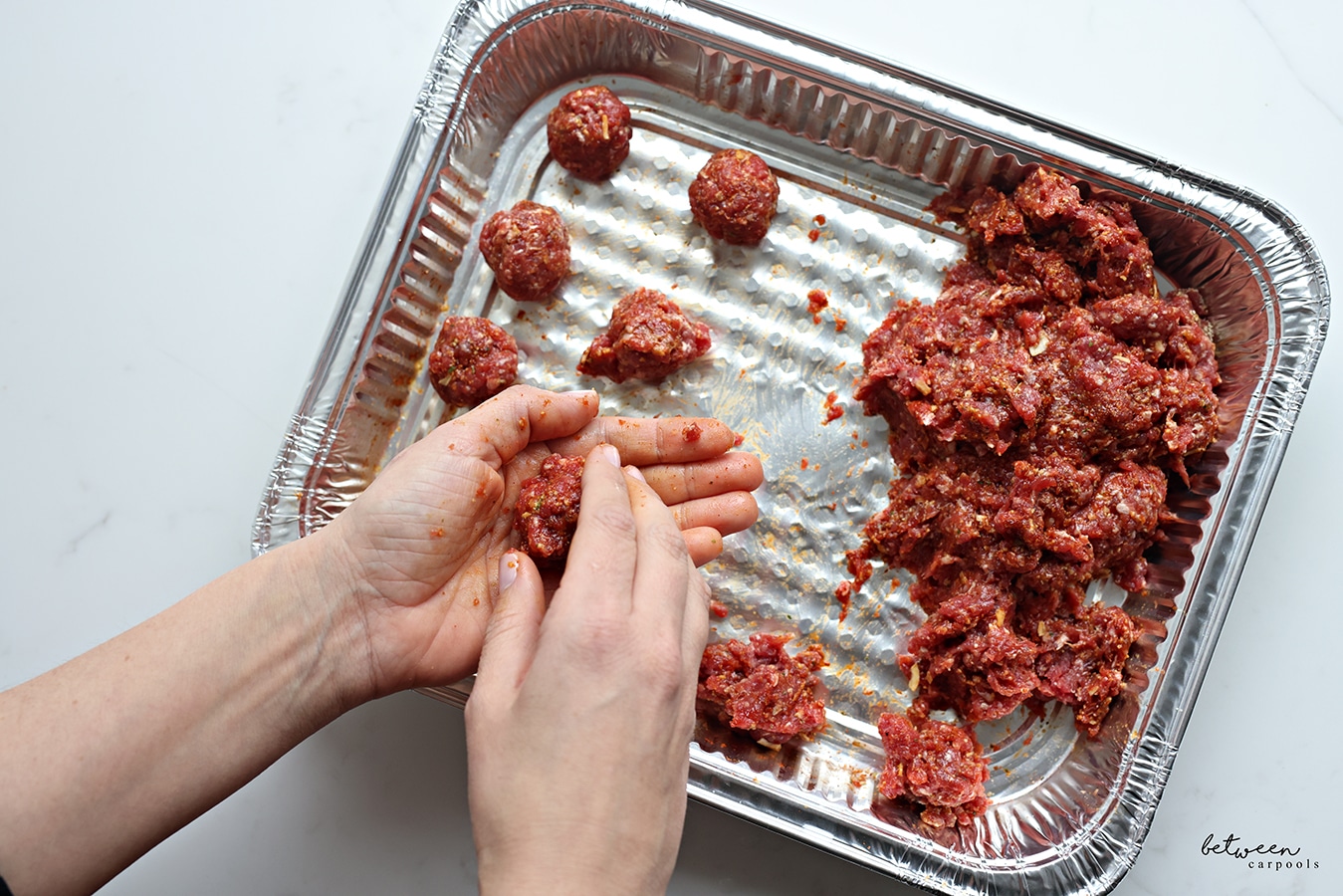 Forming meatballs in a 9x13 pan.