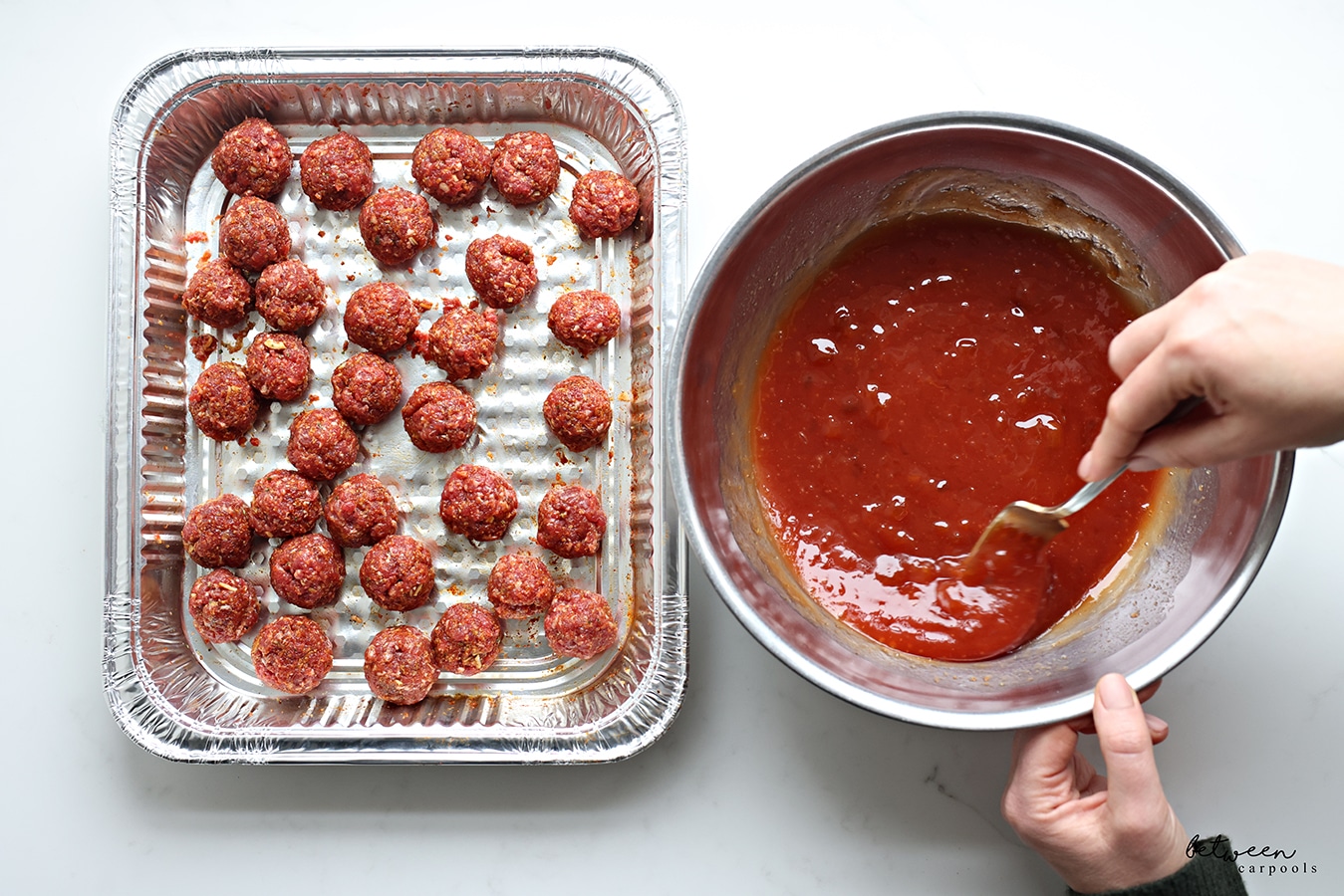 Meatballs in a 9x13 pan and sauce for the meatballs in a mixing bowl.