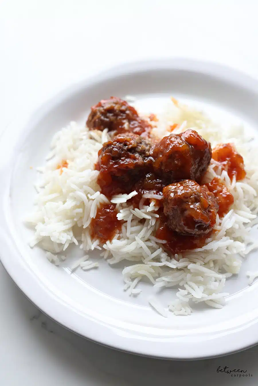 Baked meatballs and rice on a plate.