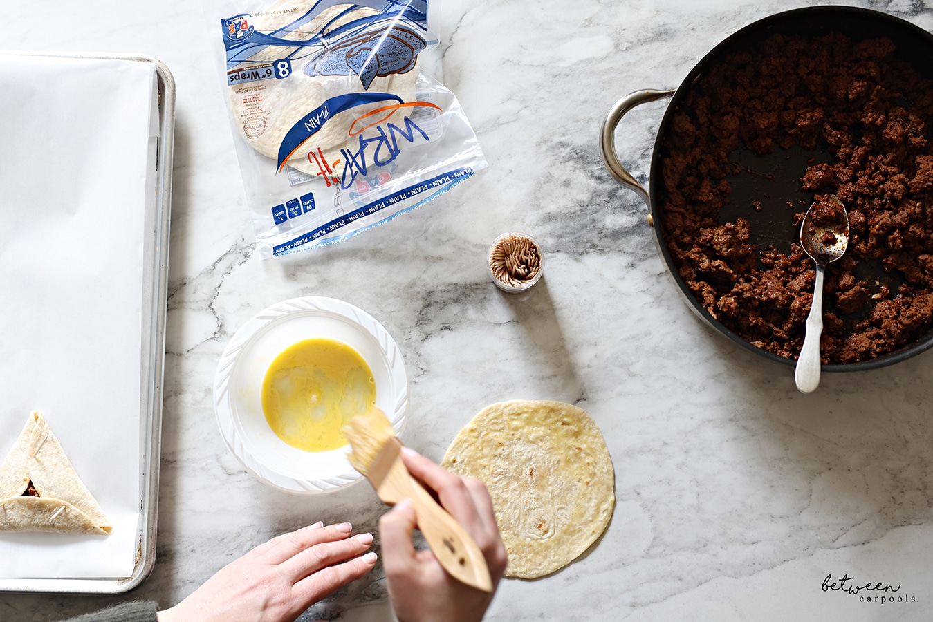 Brushing the perimeter of each tortilla with some egg wash.