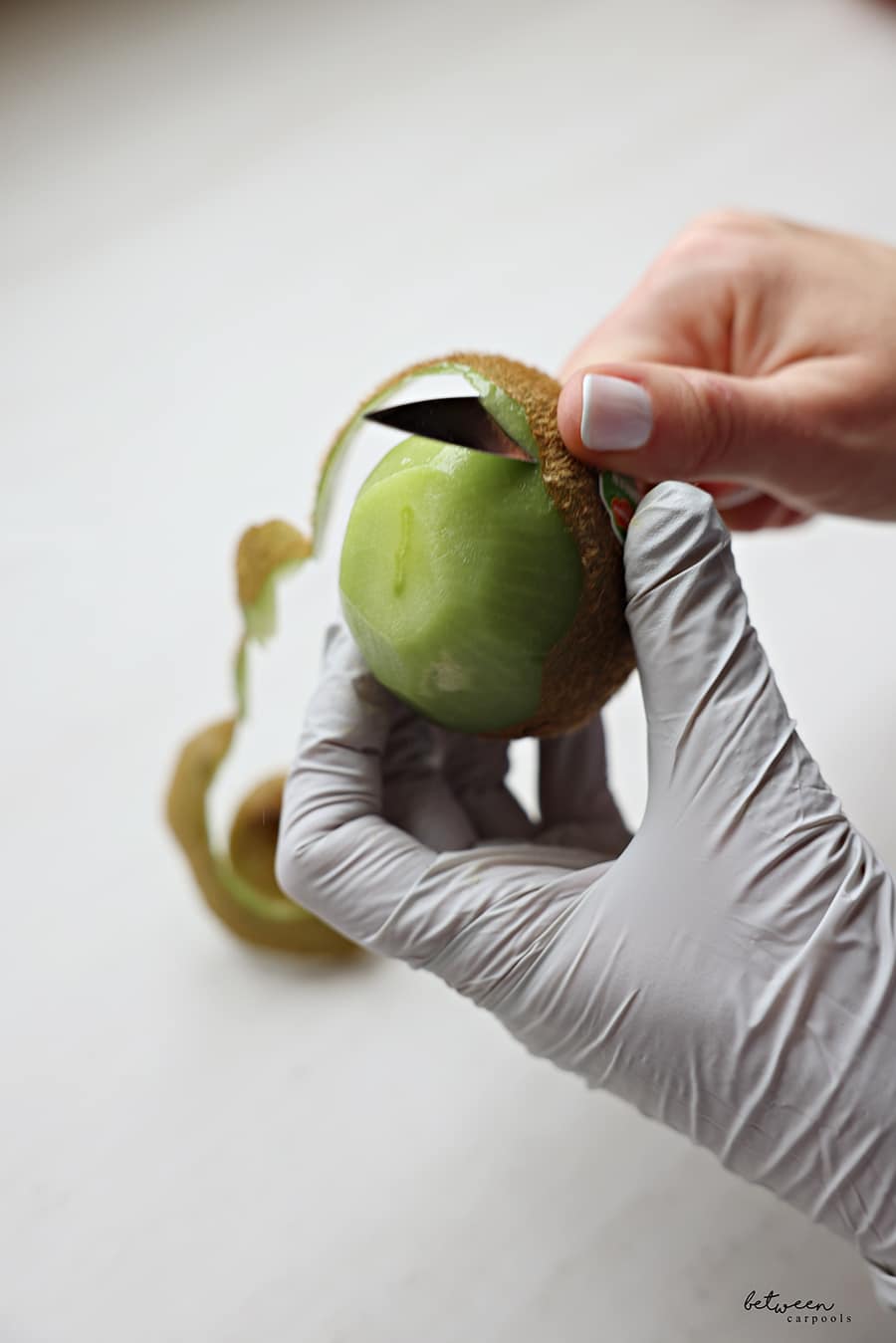 hast pairing knife peeling a kiwi in hand