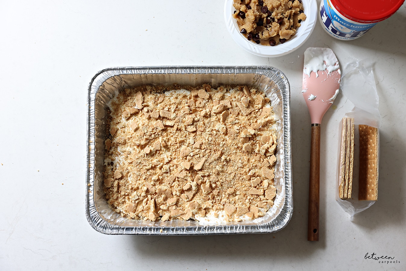 A layer of crumbled graham crackers on top of the Fluff.