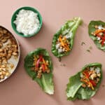 Crunchy Chicken Lettuce Tacos on pink background