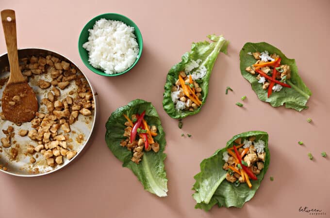 Crunchy Chicken Lettuce Tacos on pink background