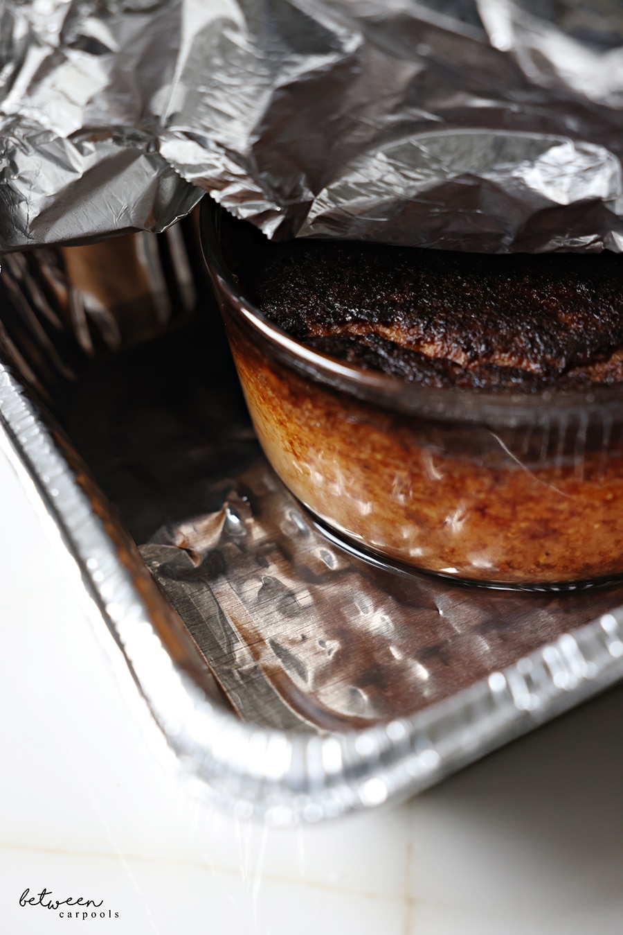 potato kugel baked in a round pyrex bowl, placed in a 9x13 foil pan